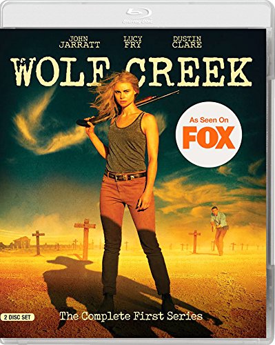 Wolf Creek" Blu-ray cover featuring a woman with a gun in a desert landscape.
