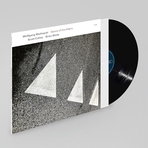 Vinyl record and album cover with abstract triangular road markings.