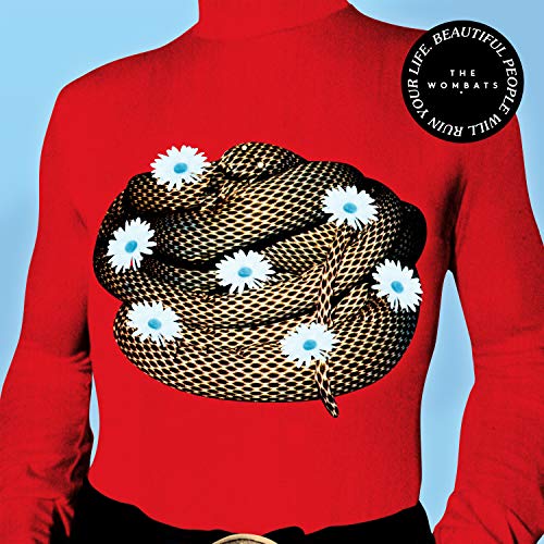 Person in a red turtleneck shirt with a snake and daisies graphic against blue.