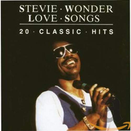 Stevie Wonder album cover featuring him with sunglasses and a microphone.