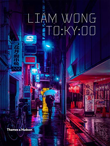 A person with an umbrella walks down a neon-lit, rain-slicked Tokyo street at night.