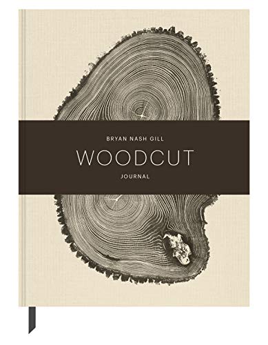 Beige journal with a detailed black and white woodcut tree ring design.