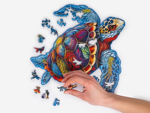 Colorful wooden turtle puzzle, partially assembled with hand placing a piece.