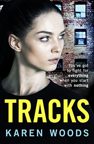 Book cover: woman’s face, brick buildings, bold yellow “Tracks” title.
