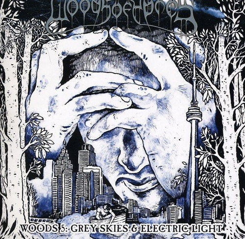A black and white album cover with hands holding a face, surrounded by trees and cityscape.