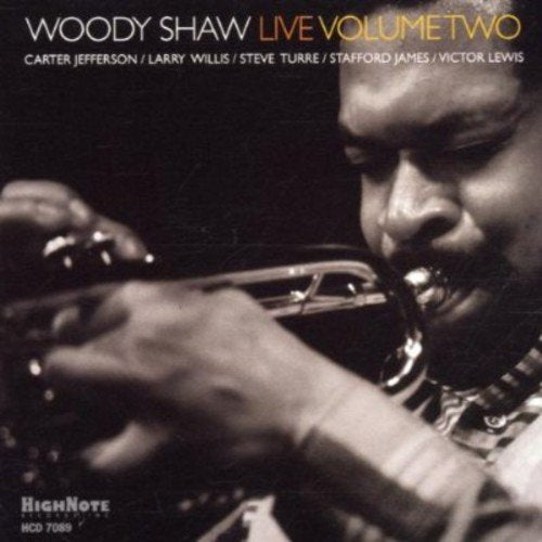 "CD cover with a man playing trumpet, close-up, black and white image."