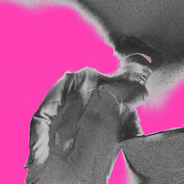 Black and white portrait of a person looking down against a pink background.