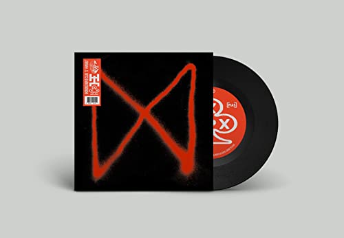 Vinyl record with red spray-painted "X" on black cover, barcode visible.
