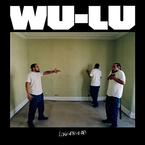 Album cover: three men in a pale green room, pointing and gesturing.