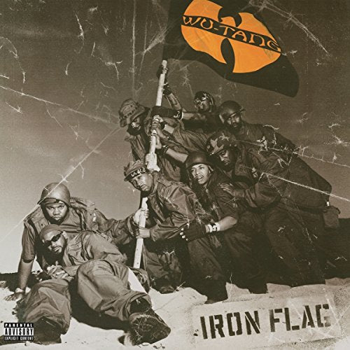 Wu-Tang Clan members in military gear raising a flag with their logo in desert.