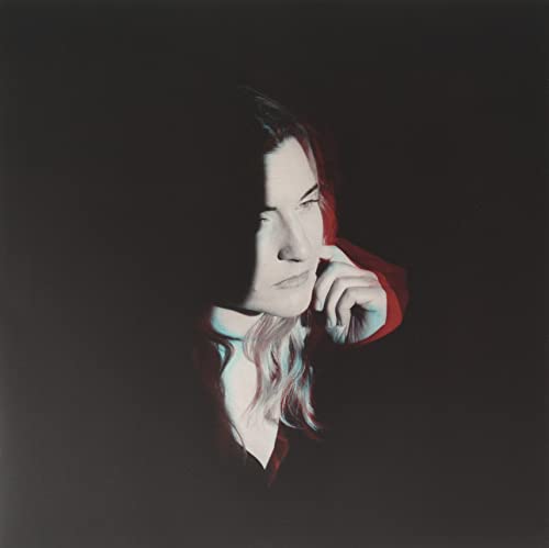 Dark portrait of a person with red and blue color separation.