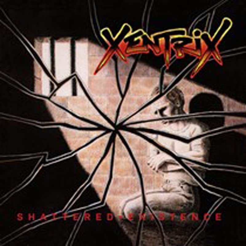 Broken glass with seated figure and brick wall in background, bold colorful band name.