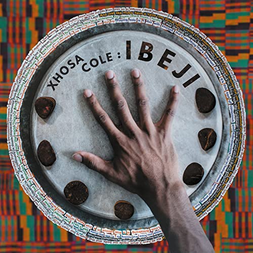 Vinyl record cover with a hand touching a drum, text “Xhosa Cole: Ibeji”.
