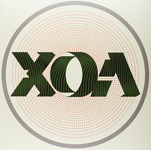 The image shows a vinyl record cover with the text "XOA" in a circular design. Alt text: Green "XOA" text in a circle with red dotted rings.
