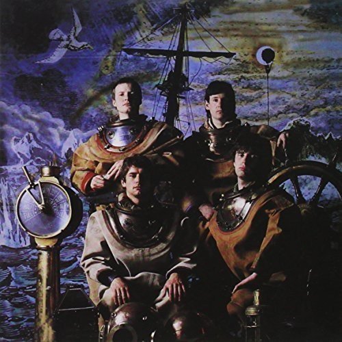 Four men in vintage deep-sea diving suits posed against a surreal nautical background.