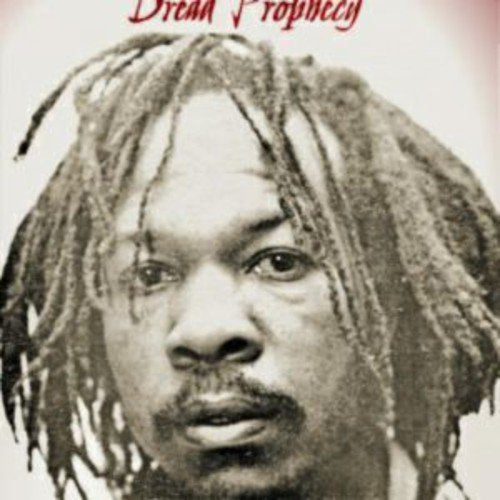 Black and white portrait of Yabby You with long dreadlocks.