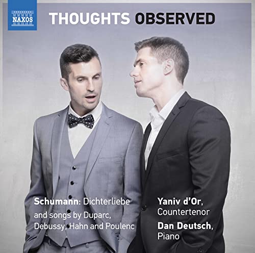 Two men in formal suits stand against a grey background on this music album cover.