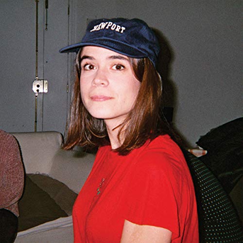 Woman with brown hair wearing a red shirt and blue baseball cap.