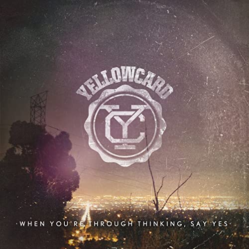 Yellowcard album cover: textured yellow and dark landscape with city lights.