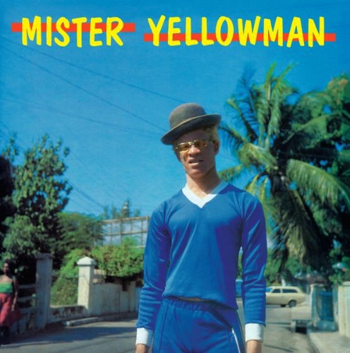 "Album cover with a man in blue outfit and hat standing outdoors."