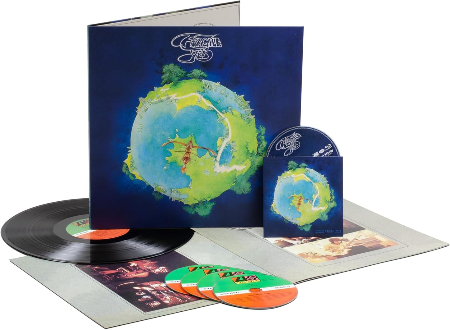 “Fragile” album cover with CDs, vinyl record, and accompanying papers.