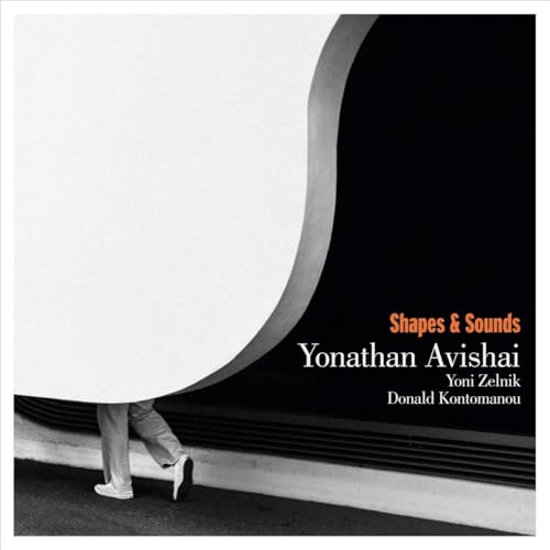 CD cover with abstract shapes, a person’s legs, and text details.