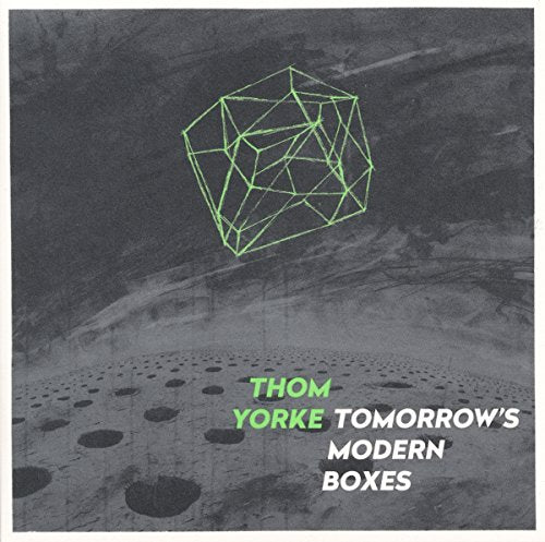 Thom Yorke's album cover featuring a green geometric shape on a grey, cratered surface.