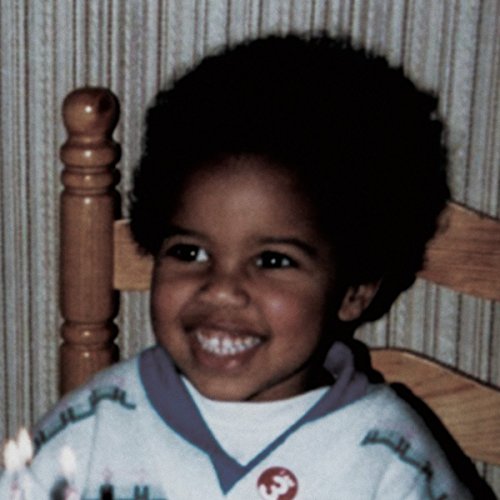 Young Fathers CD cover: a smiling young child with afro hair.