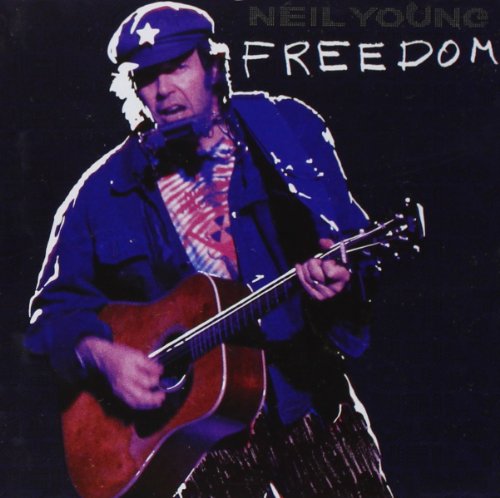 Neil Young album cover featuring the musician playing guitar on a dark background.