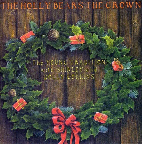 Holly wreath with red ribbons and gifts on a wooden background.