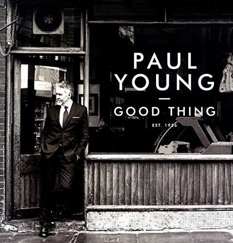 Black and white vinyl album cover with man in suit standing in a doorway.