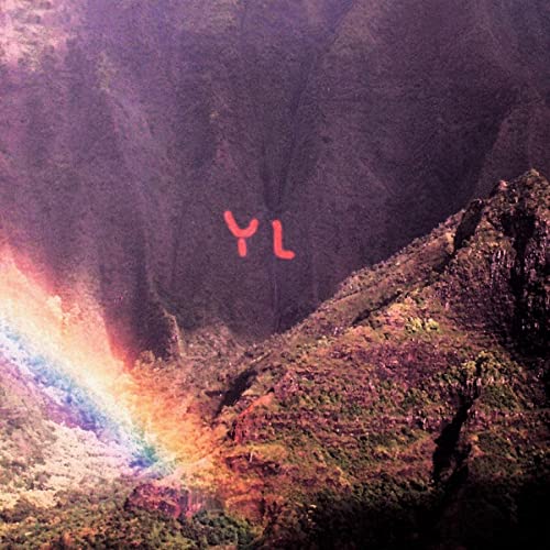 Mountain landscape with a rainbow and large red “YL” letters.