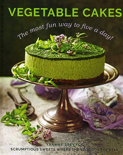 A green vegetable cake topped with herbs sits on a pedestal cake stand.