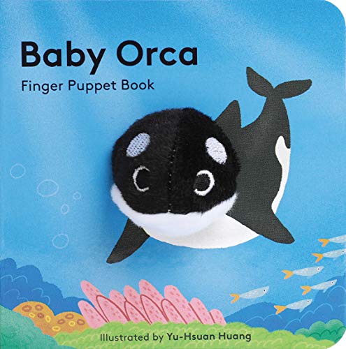 A plush orca finger puppet attached to the cover of a Baby Orca book.