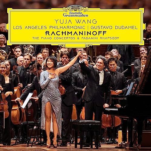 Yuja Wang and Gustavo Dudamel stand before an orchestra on a yellow-bordered album cover.