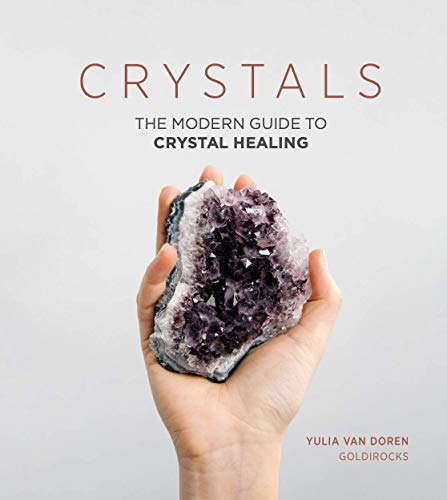 Book cover with title “Crystals” and a hand holding amethyst.