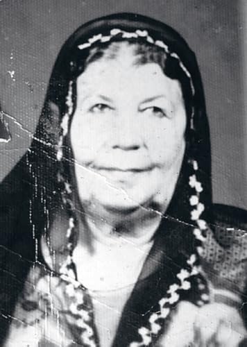 Black and white portrait of an older woman with a headscarf.