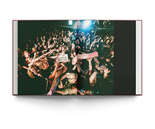 Open photo book displaying a crowded concert with raised arms and hands.
