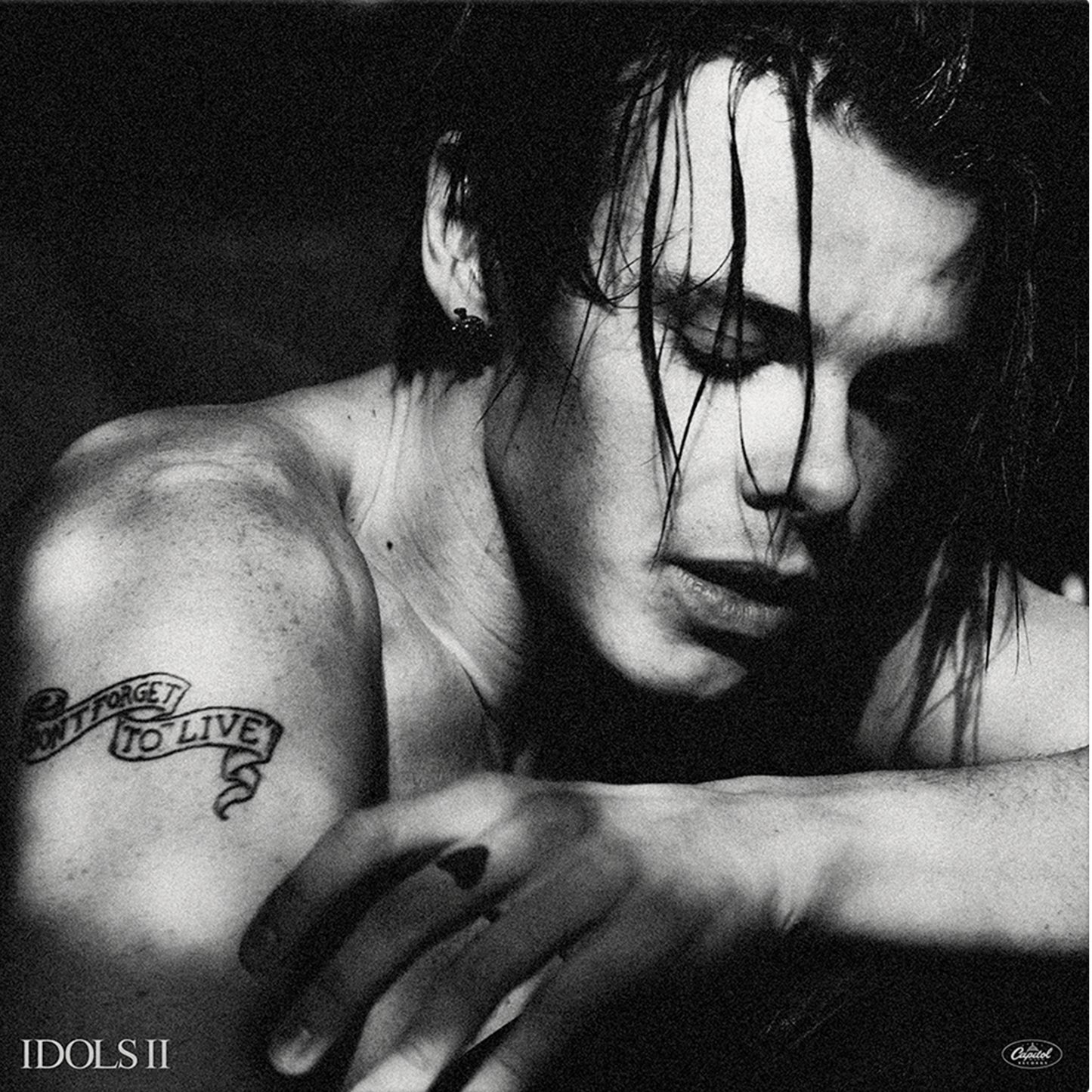 Black and white portrait of YUNGBLUD with tattoos, album cover art.