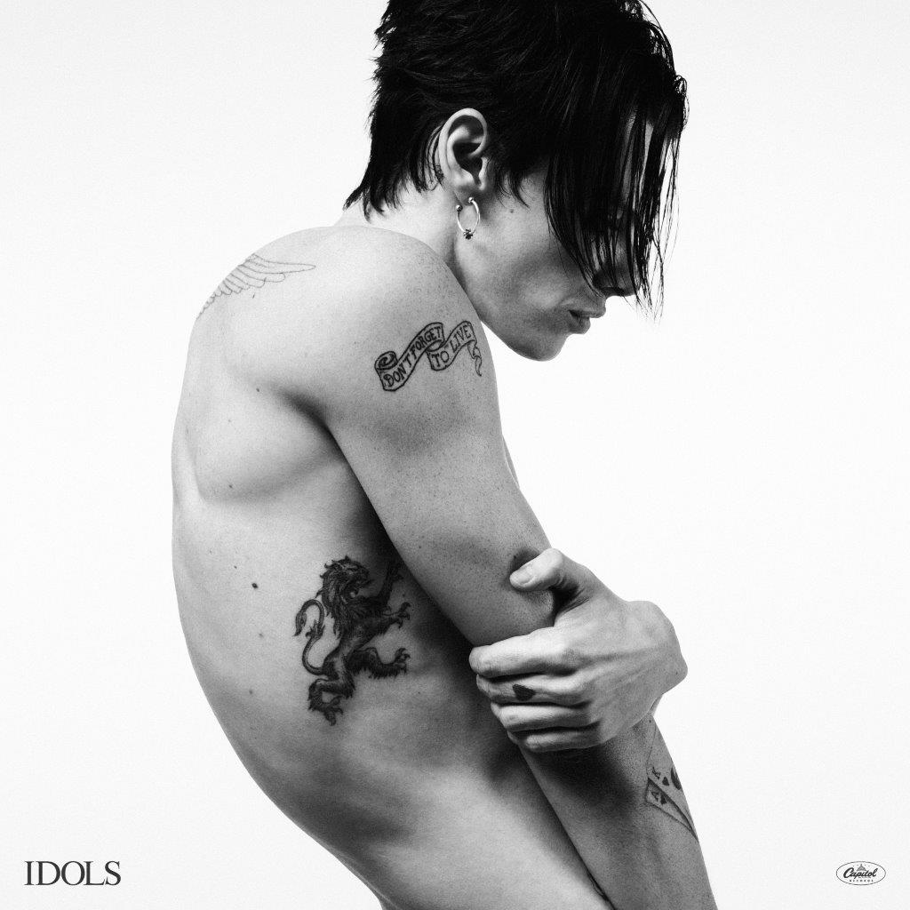 Black and white portrait of YUNGBLUD with visible back tattoos.