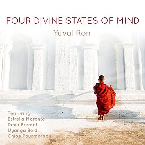 A monk in red robes stands before a white wall, album cover for Yuval Ron.