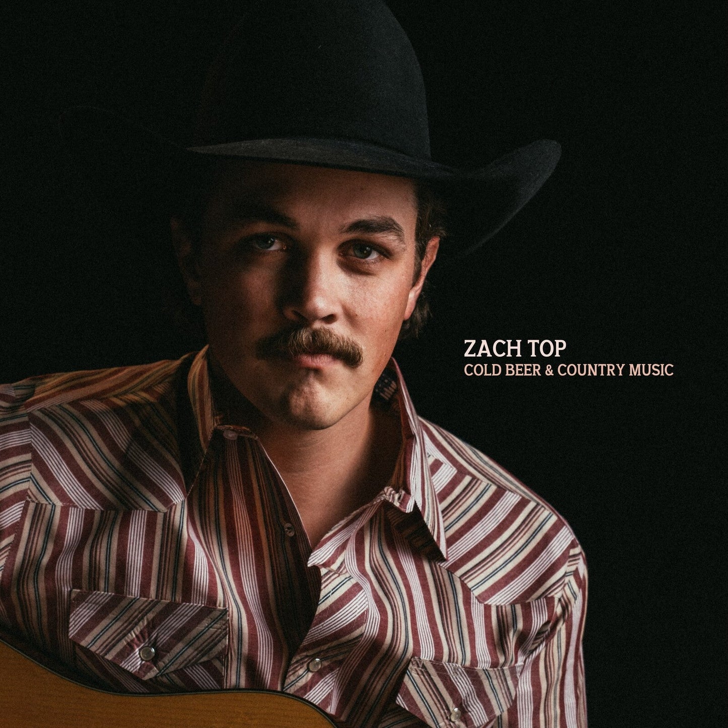 Album cover with a person wearing a cowboy hat and striped shirt, holding a guitar, with 'Zach Top' and 'Cold Beer & Country Music' text.