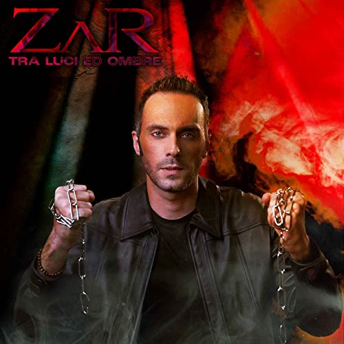 CD cover featuring a man with chains against a red and black background.