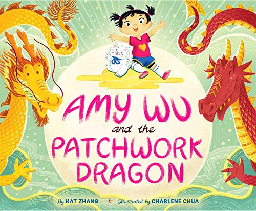 A young girl and a white cat sit between large yellow and red dragons.