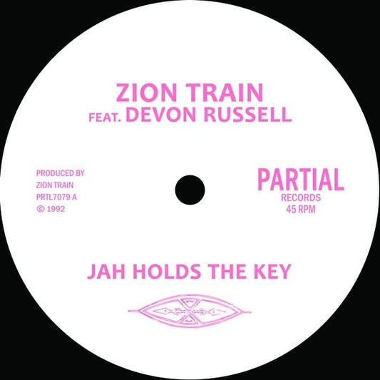 Pink vinyl record label with text: “Zion Train Feat. Devon Russell”.