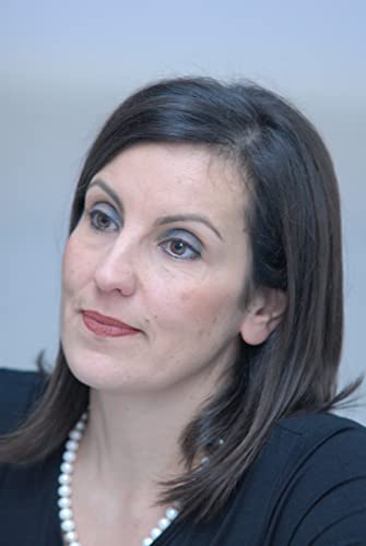 Headshot of a woman with dark hair and a pearl necklace.