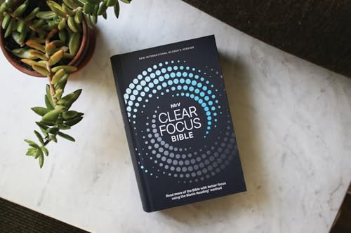 Charcoal and blue hardcover Bible with a circular dot pattern.