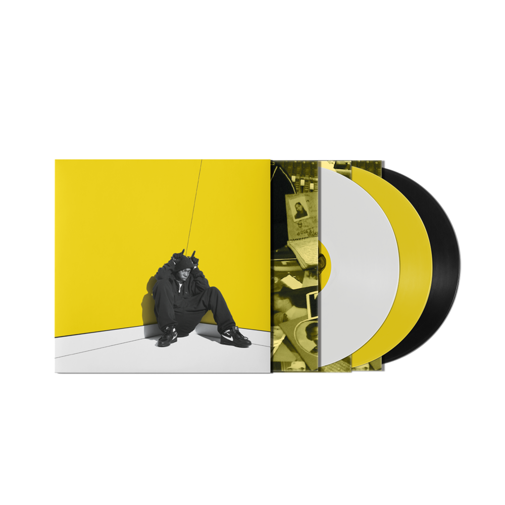 "Three vinyl records, one yellow, one white, one black, in a sleeve."
