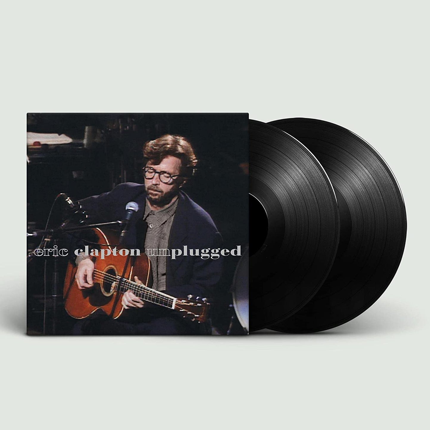 "Eric Clapton Unplugged vinyl record cover with two black vinyl records partially visible."