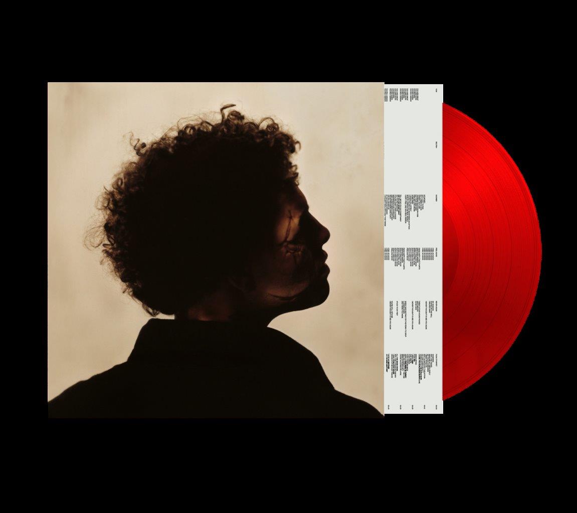 "Red vinyl record with album cover featuring a man's silhouette profile."